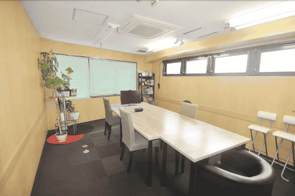 A room with a large table in the middle