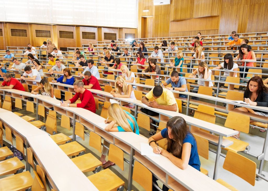 Large group of students doing exam.